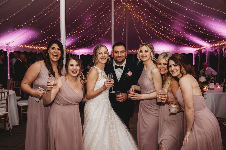 Wedding bistro lights in tent with pink uplighting