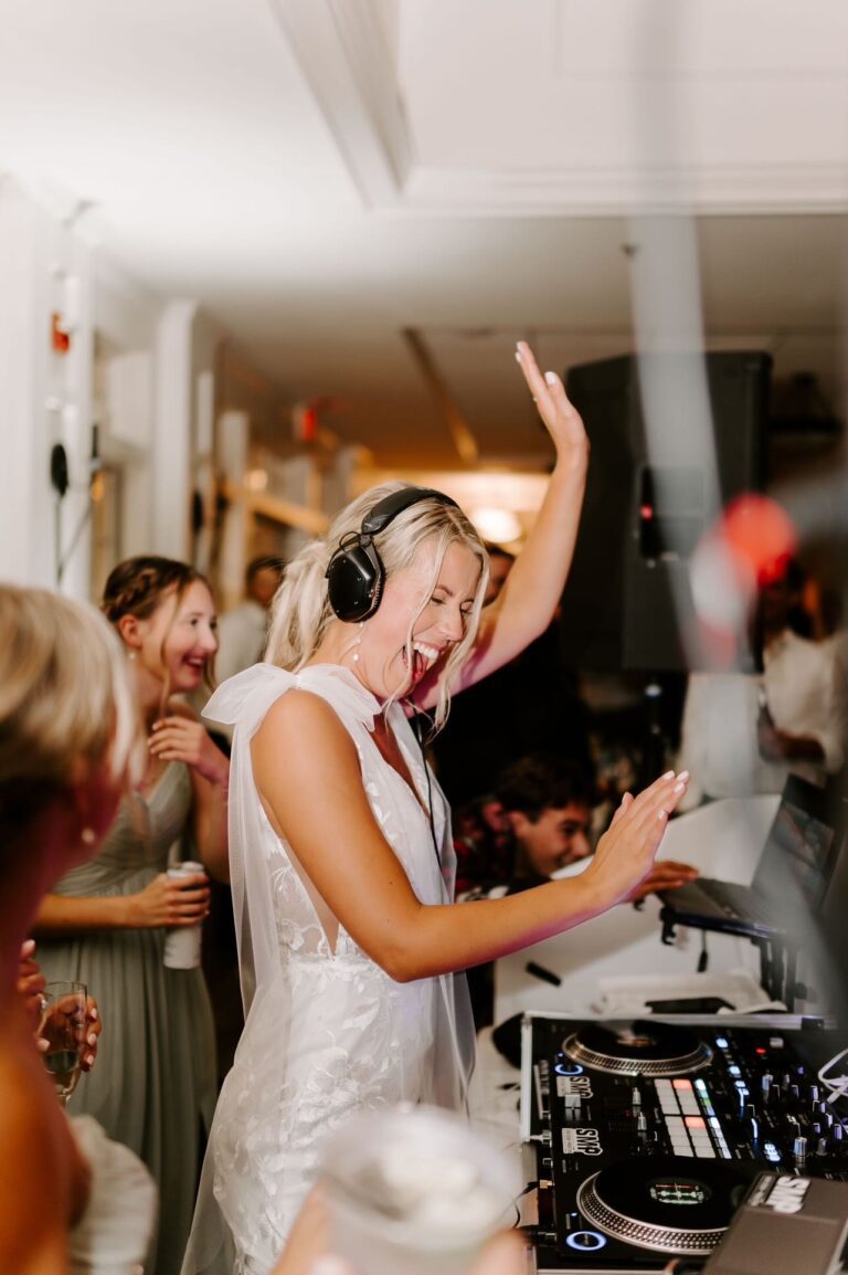 Bride at DJ booth at Pinehills Golf Club wedding