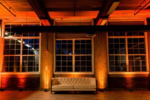 Wireless professional uplights installed cleanly around ballroom perimeter